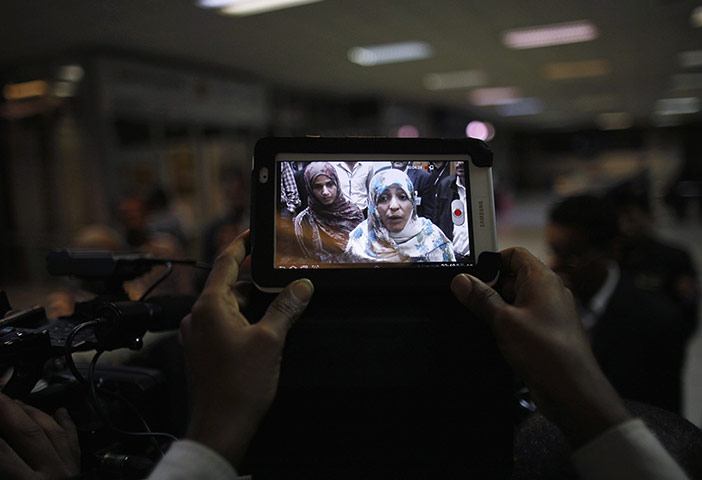 20 Photos: A man takes a photo of Nobel Peace Prize winner Tawakul Karman of Yemen