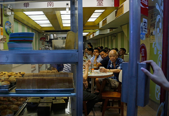 Weekend in pictures: Hong Kong: Elderly men sit in a tea restaurant in Sham Shui Po district whi