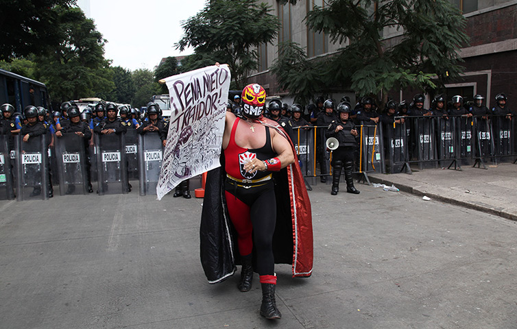 Weekend in pictures: Mexico City, Mexico: A protester dressed as a wrestler representing the Mex