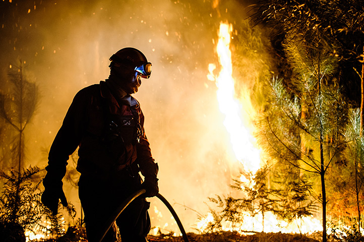 Weekend in pictures: Amares, Portugal: A fireman struggles to extinguish wildfire in the north o