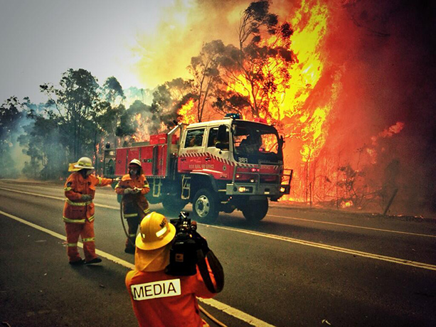 West Sydney bushfires: Firefighters and media crew at the site of a grass fire in northwest Sydney