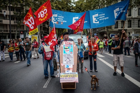 People march with a coffin as part of a nationwide day of protest against the government's plans to reform France's debt-ridden pension system, on September 10, 2013 in Lyon.