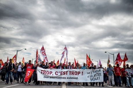 People march as part of a nationwide day of protest against the government's plans to reform France's debt-ridden pension system, on September 10, 2013 in Lyon