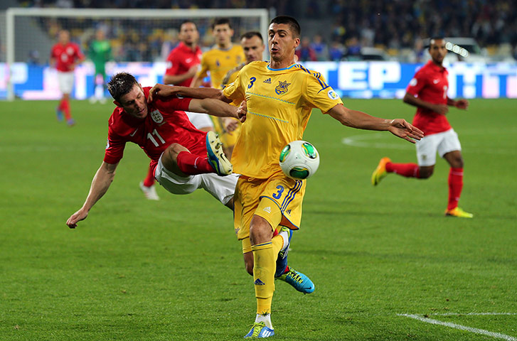 Ukraine v England: James Milner and Yevhen Khacheridi battle for the ball