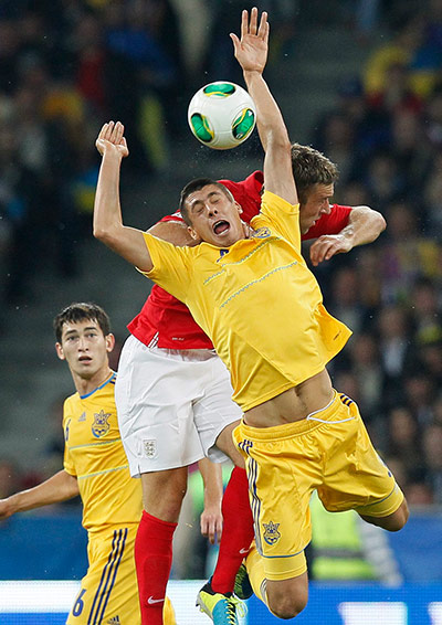 Ukraine v England: Yevhen Khacheridi and Rickie Lambert go up for a ball