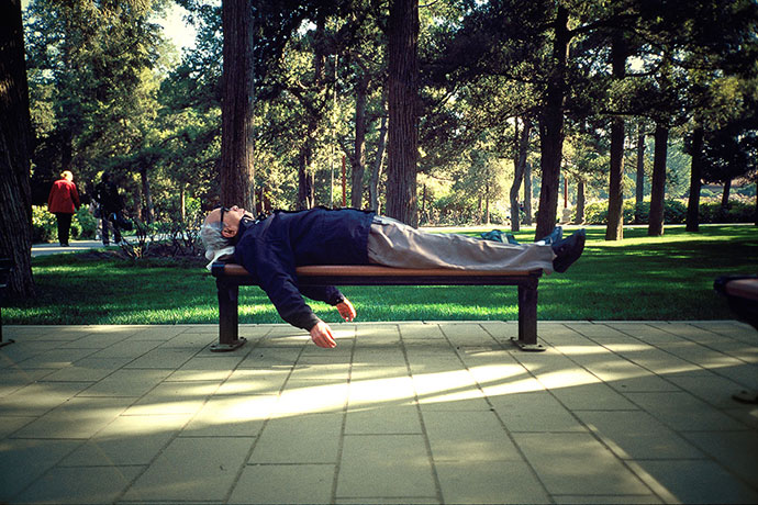 Big Picture - Daydreamers: man lying on bench in park sleeping