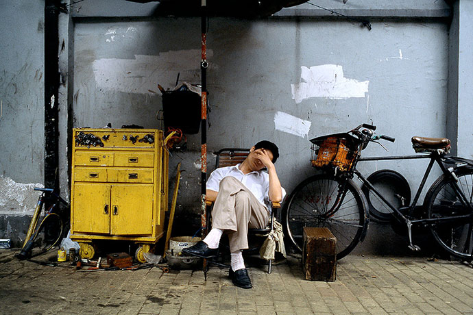 Big Picture - Daydreamers: Man lying on deckchair next to bicycle