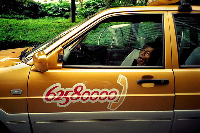 Big Picture - Daydreamers: Man in yellow taxi sleeping