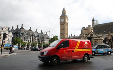 A Royal Mail passes the Houses of Parliament behind it, in central London, September 12, 2013.