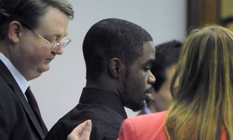 De'Marquise Elkins stands with his lawyers as he is sentenced.