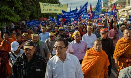 Thousands of Cambodian National Rescue Party supporters march with opposition leader Sam Rainsy through Phnom Penh to protest against election results.