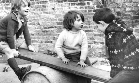 Children play on makeshift seesaw
