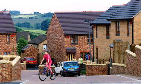 Girl cycling outside housing
