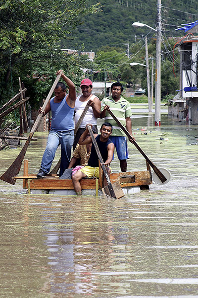 mexico floods: Residents attemp to cross a flooded street