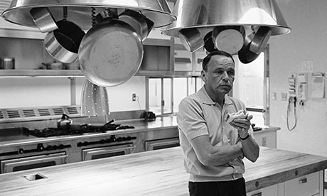 Entertainer Frank Sinatra eating a sandwich 