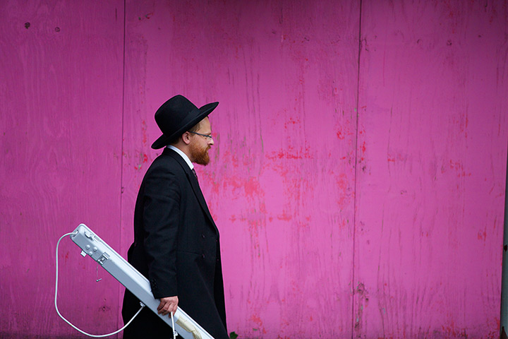 Sukkot preparations: A Jewish man carries a light fitting for his sukkah in Broughton, Greater Manchester