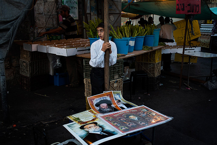 Sukkot: An ultra-Orthodox Jewish street vendor sells pictures of rabbis in Jerusalem