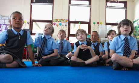 School children listen to teacher