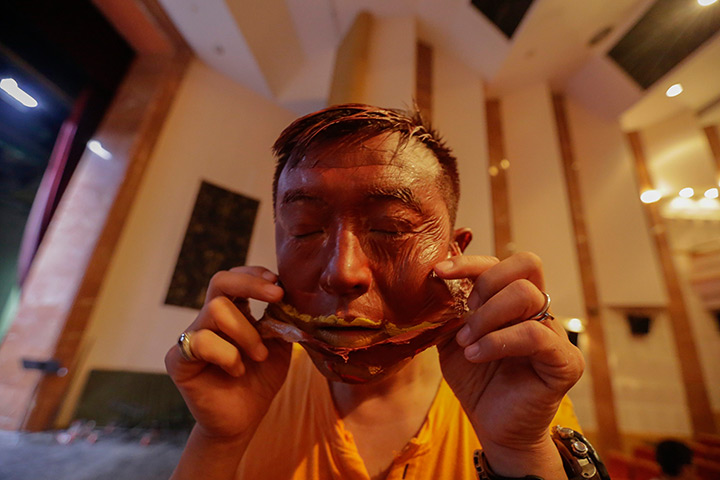 FTA: Jason Lee: Artist Liu Bolin removes a face mask after his latest project in Beijing