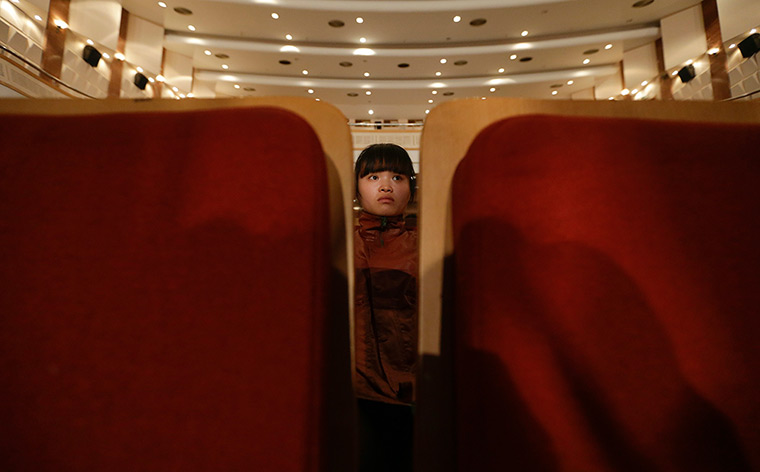 FTA: Jason Lee: A participant waits to be painted in Beijing