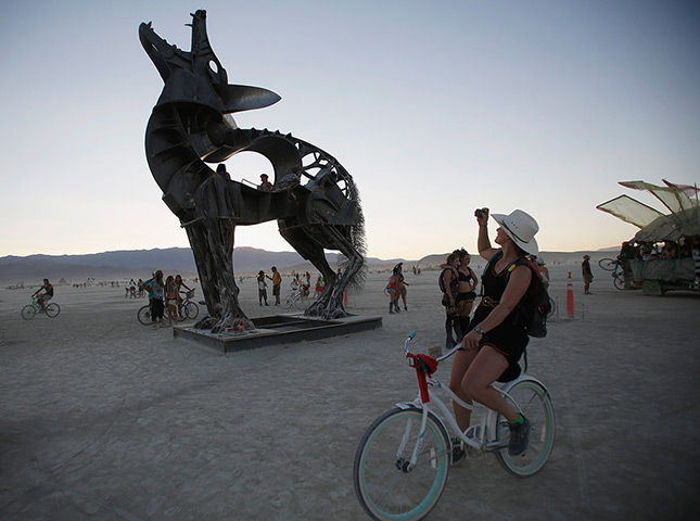 Burning Man 2013: A woman photographs an art installation 