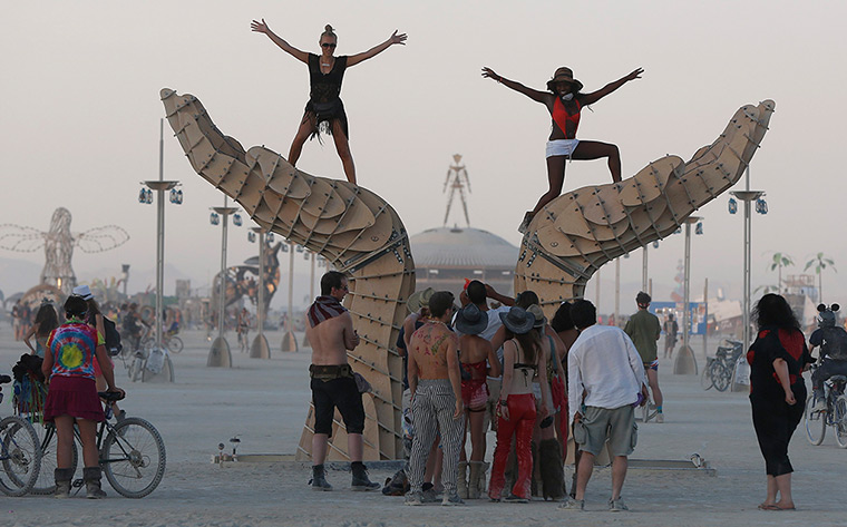 Burning Man 2013: Women pose for photos on an art installation