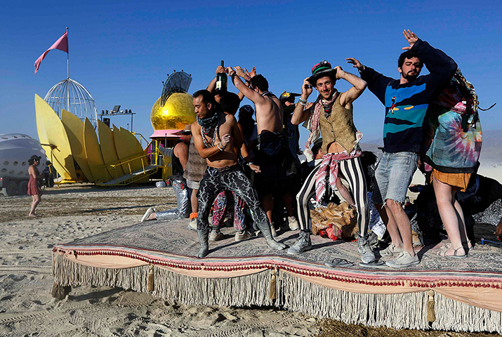 Burning Man 2013: Participants dance on a moving hookah lounge art car 