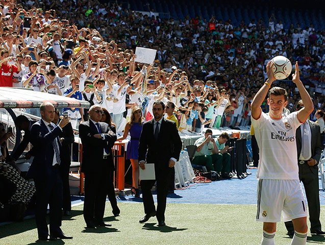 Bale arrives in Madrid: Bale winks and smiles to his fans during his presentation on the pitch