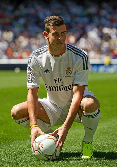 Bale arrives in Madrid: At last Gareth Bale poses for photographs in his new Real Madrid shirt