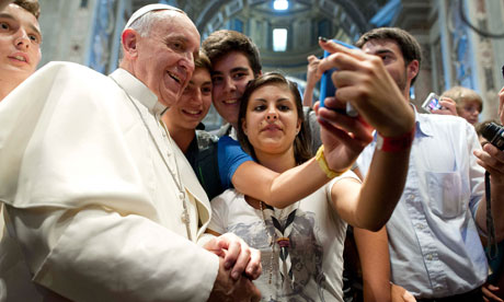 Pope Francis poses with youths in Saint Peter's Basilica at the Vatican