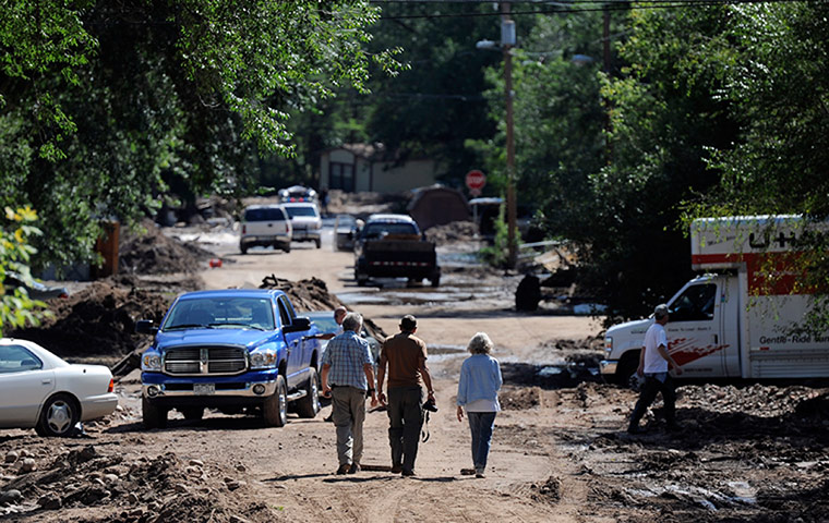 colorado after flood: People walk through a severely