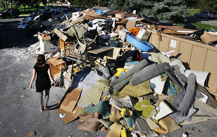 colorado after flood: A woman looks for reclaimable wood 
