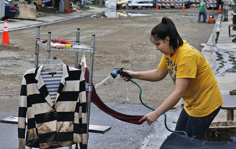 colorado after flood: Samantha Fennell sprays mud 
