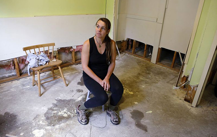 colorado after flood: Jessica Klauzer-Zimmerman sits in her bedroom
