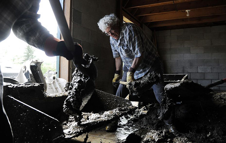 colorado after flood: Stan Koleski, 65, shovels mud f