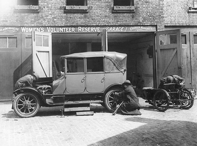 Woman mechanic repairing a car at a Women's Volunteer Reserve garage
