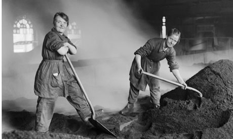 Women feed the charcoal kilns used for purifying sugar at a refinery in Scotland, circa 1916. 