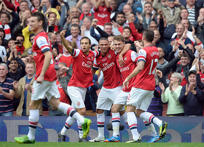 football: Arsenal's Aaron Ramsey is congratulated
