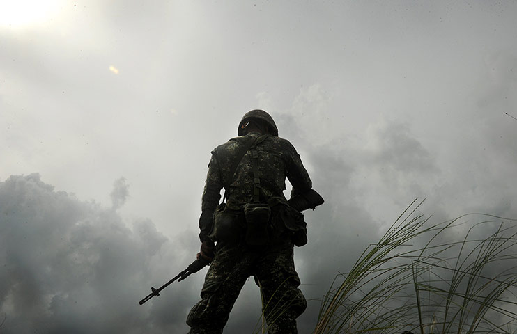 Weekend in pictures: A Philippine marine walks among grass 