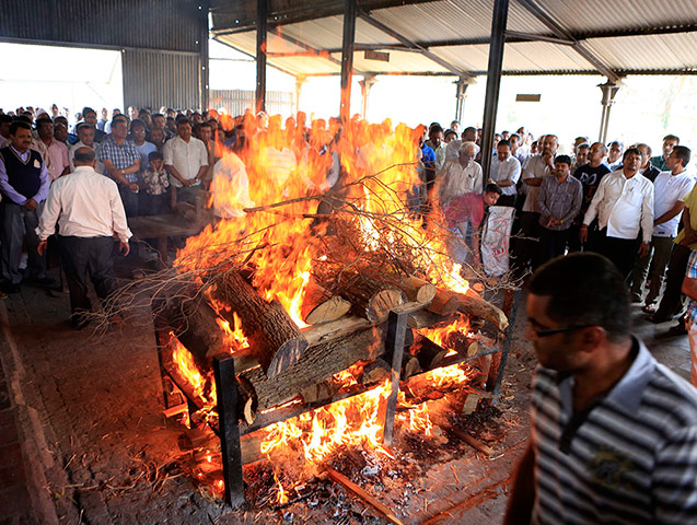 Weekend in pictures: The body of a victim killed at a shopping mall shooting spree is cremated