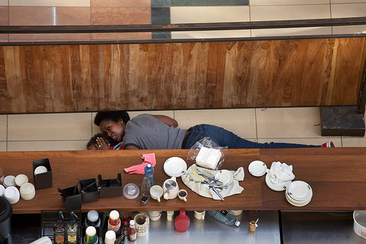 Nairobi mall siege: woman and a child take cover