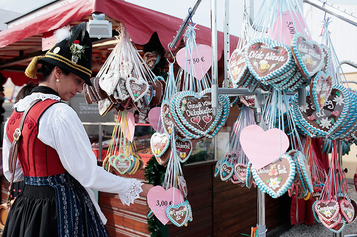 oktoberfest: Woman wearing a traditional Bavarian clothing looks for gingerbread hearts
