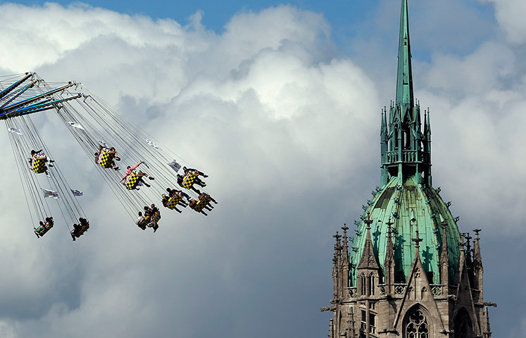 oktoberfest: People enjoy a swing ride in front of the St. Pauls church 