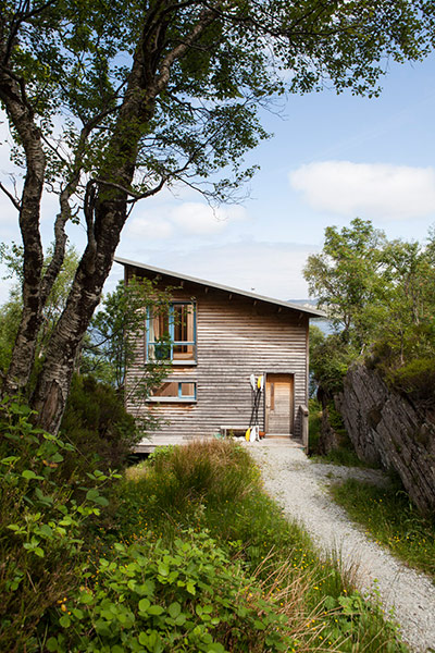 Homes - On The Rocks: wooden house surrounded by green landscape