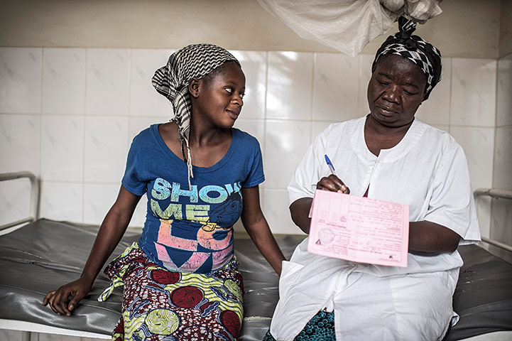 Making babies: A nurse makes notes after having examined a pregnant woman