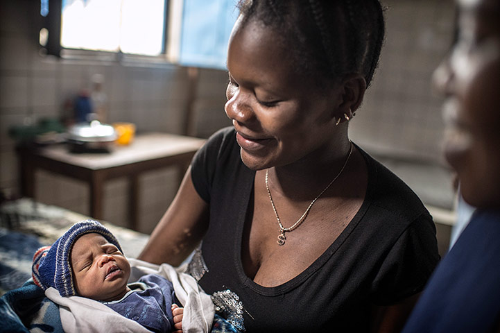 Making babies: Nurse and mother admiring a new born child 