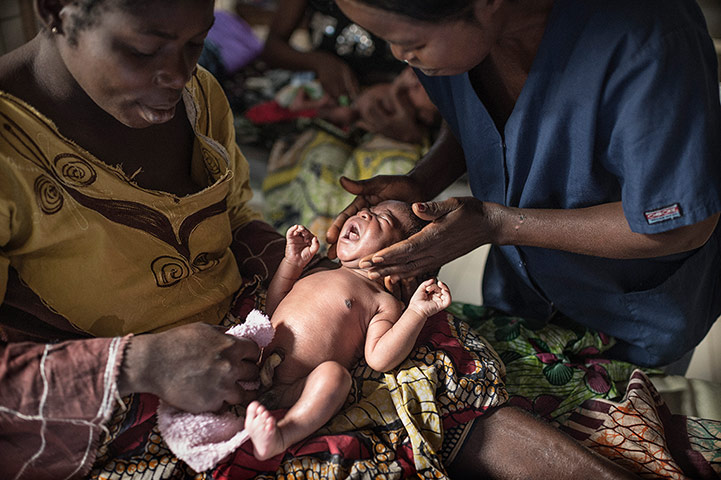 Making babies: Nurse and mother clean and care for a newborn child