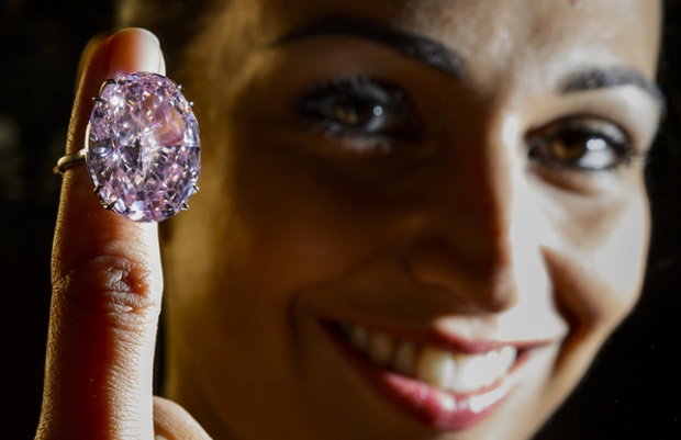 A model shows a 59.6-carat pink diamond that will be auctioned by Sotheby's in Geneva in November at a record asking price of £37 million. 