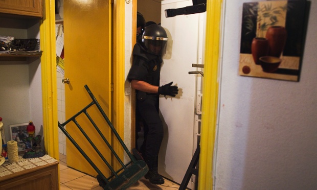 Police remove the door and push away a refrigerator as they break into Maria Isabel Rodriguez Romero's apartment to evict her and her family in Madrid. Rodriguez Romero has lived in an apartment of the State City Hall Housing Company for 24 years and they have paid a debt of 1200 euros but EMVS informed them they still had to move out. The eviction was executed despite of the resistance of dozens of Victims' Mortgage Platform activists.