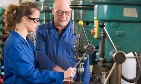 Two machinists working on machine